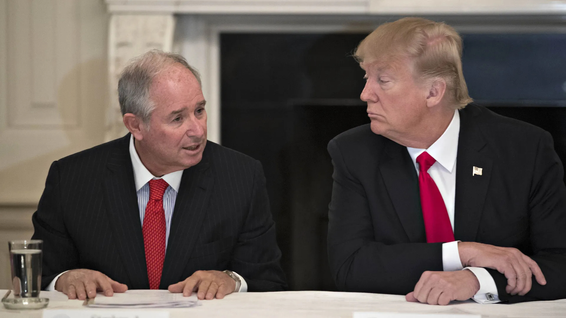 Billionaire co-founder and chief executive of investment group Blackstone, Stephen A. Schwarzman [left], announces his support for Trump. 

Image Source: Axios 