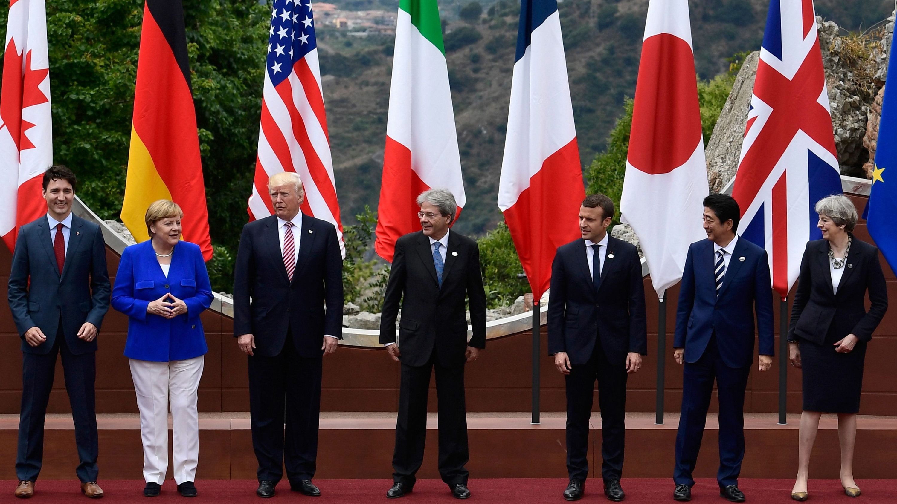 Canadian Prime Minister Justin Trudeau, German Chancellor Angela Merkel, US President Donald Trump, Italian Prime Minister Paolo Gentiloni, French President Emmanuel Macron, Japanese Prime Minister Shinzo Abe, and Britain's Prime Minister Theresa May at the G7 summit, held at the ancient Greek Theatre of Taormina, Sicily on May 26, 2017. 

Image Souce: CNN 