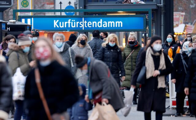 People wearing protective face masks stroll along the Kurfürstendamm, Germany shopping boulevard. 

Image Source: Reuters 